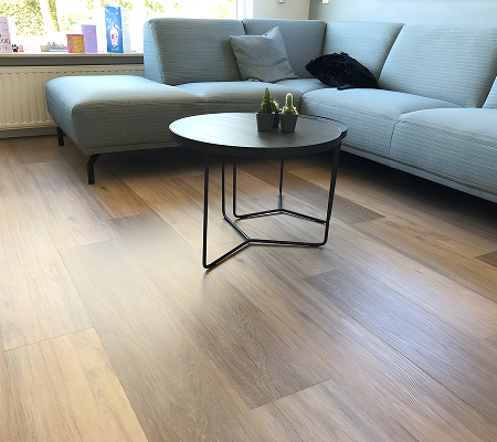 Modern living room with light wood flooring.