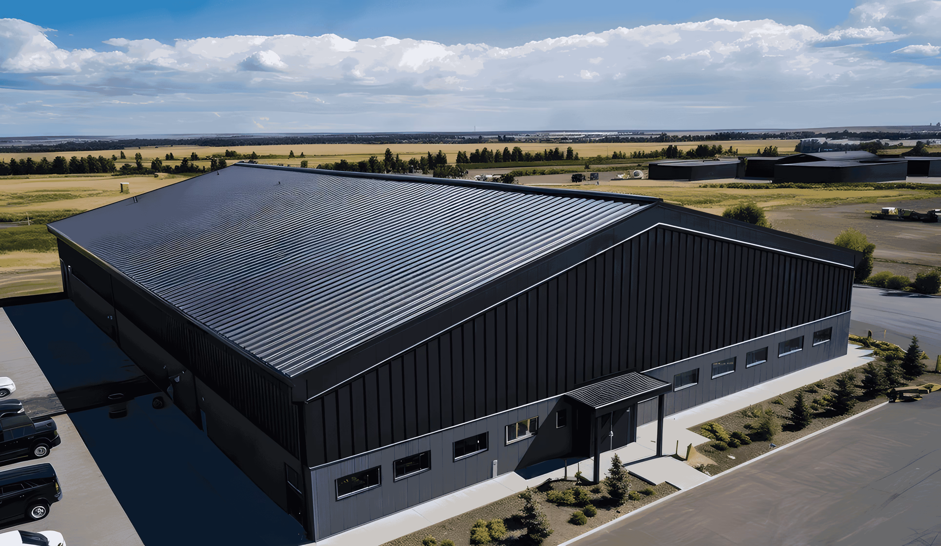 large industrial warehouse showing a professional commercial roofing project with a black standing seam metal roof installation
