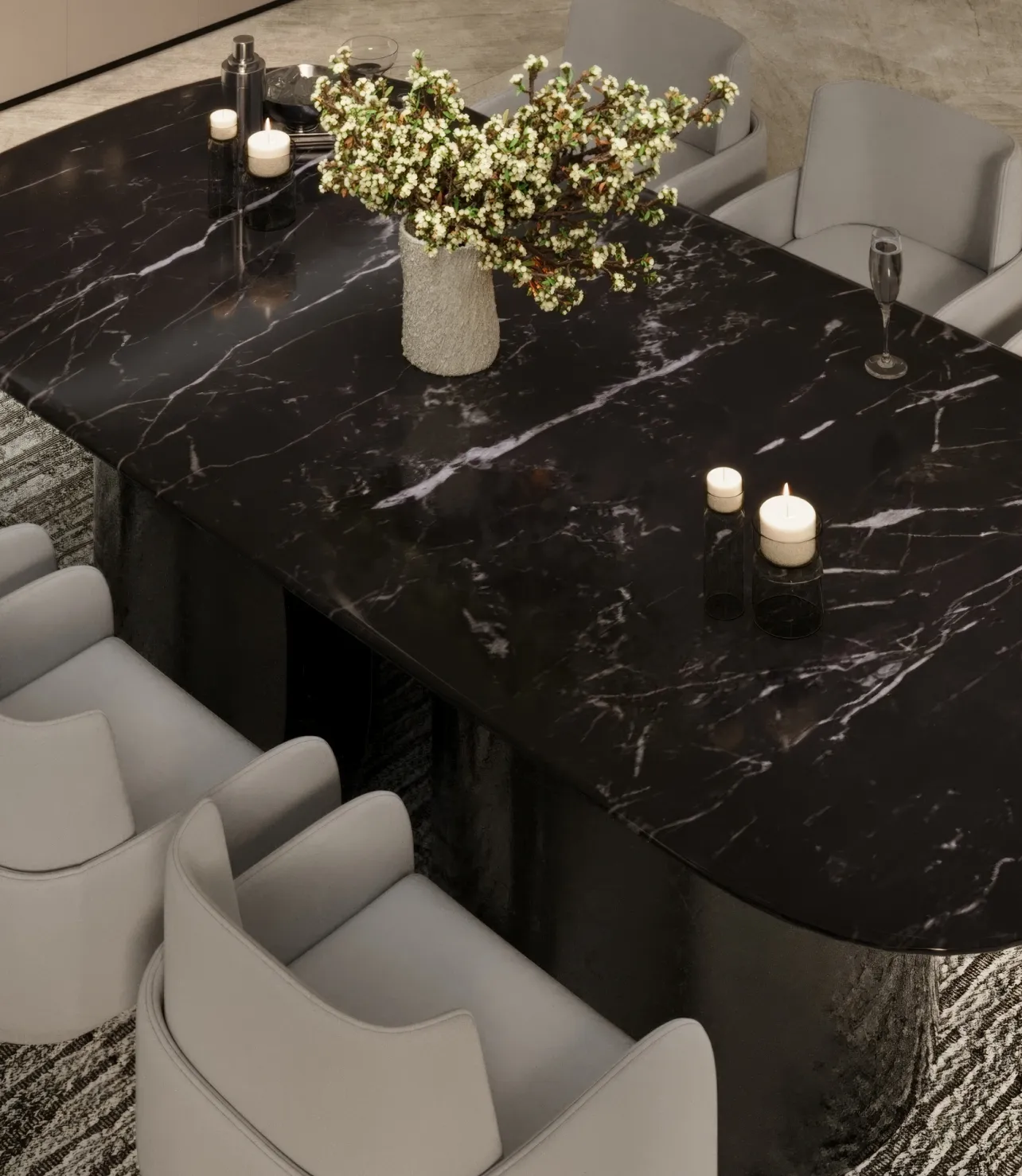 Black marble dining table with candles and floral centerpiece