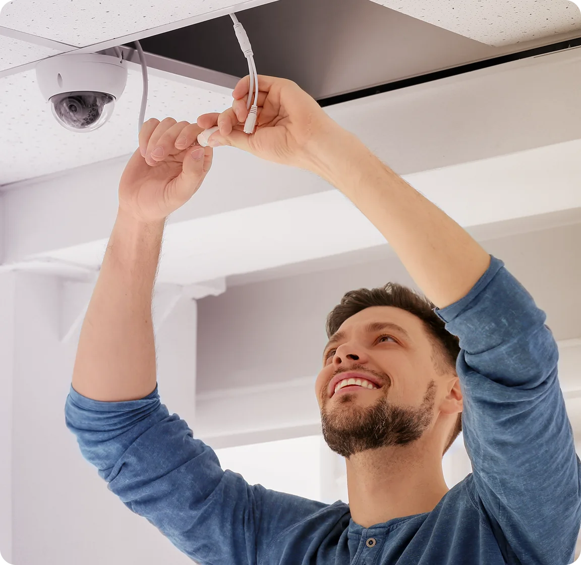 US security camera installer fitting a security camera at a commercial property.