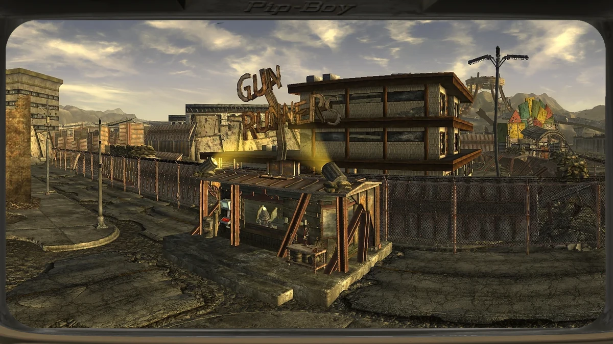 Kiosko de los Contrabandistas en Fallout: New Vegas con el robot Vendortron tras el cristal y la valla de la fábrica al fondo, en el Yermo de Mojave