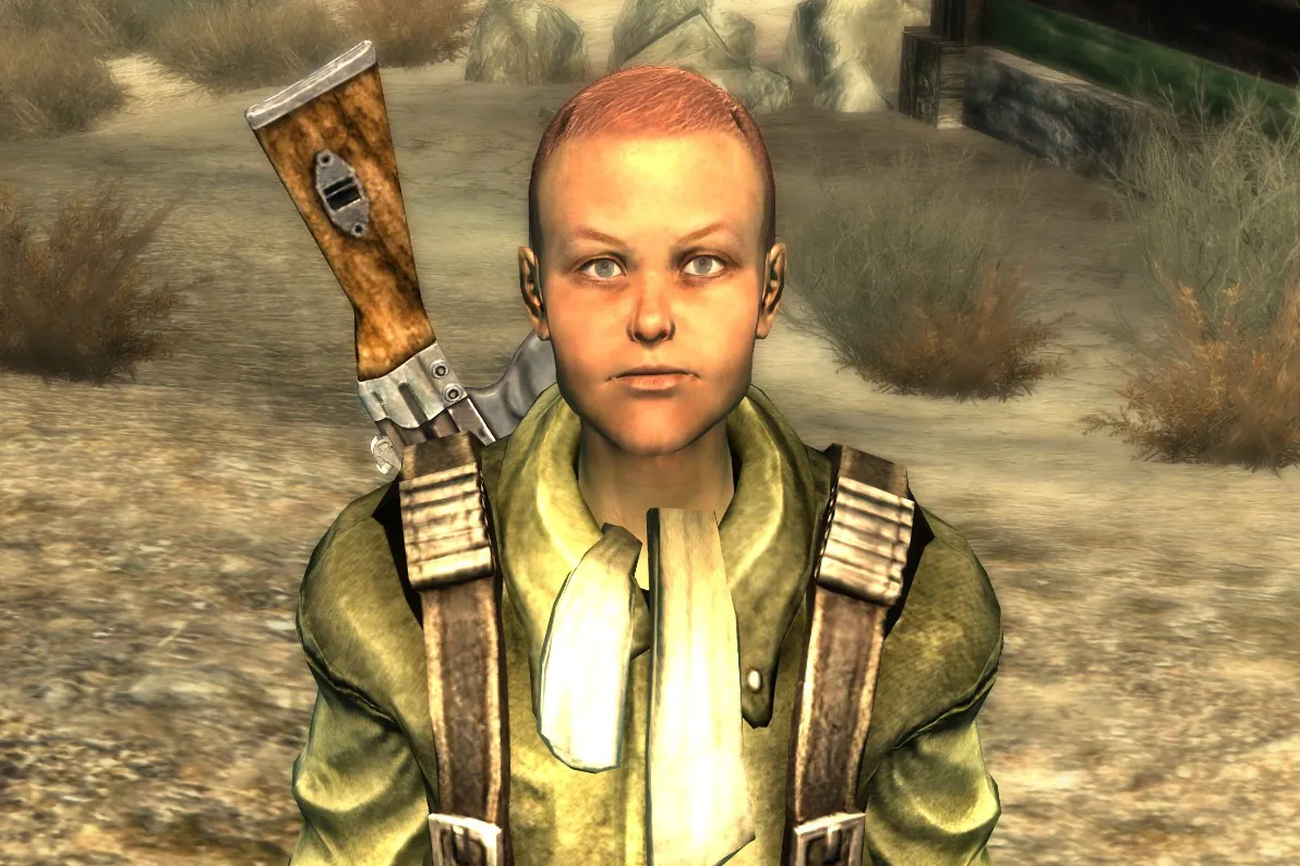 MacCready de niño sin casco, con chaqueta verde y fusil a la espalda, en el Yermo Capital de Fallout 3