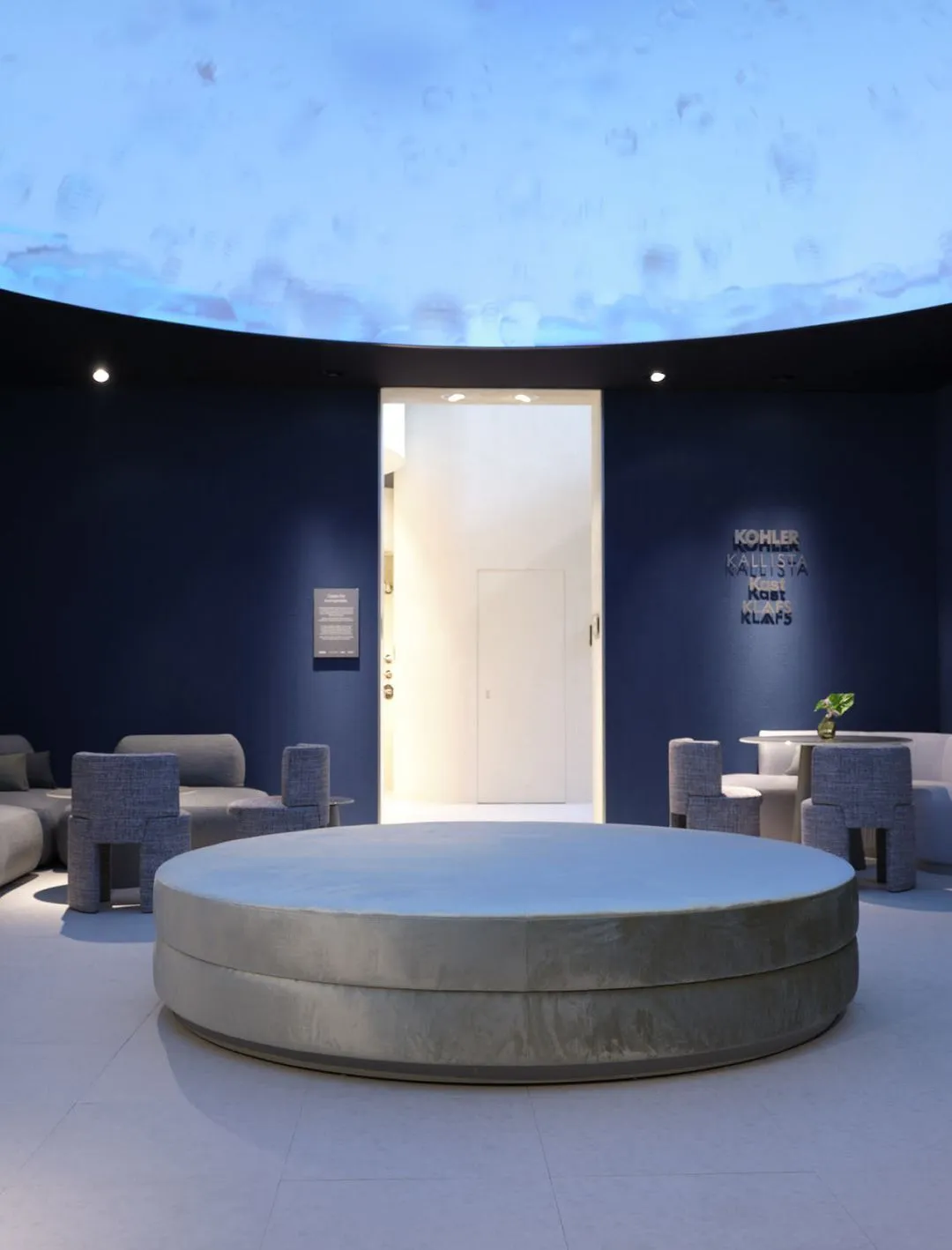 Modern interior space with circular gray seating in the center and blue walls, featuring small tables and chairs, under a large dome with a blue sky pattern.