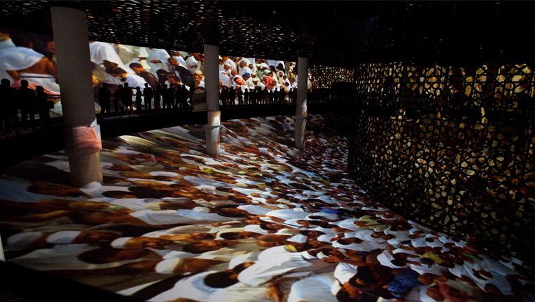 Indoor exhibition space with illuminated display panels and patterned floor art installation