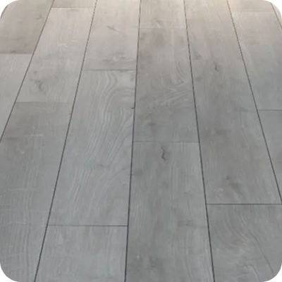 Light gray wood flooring with natural grain texture and slightly worn finish.