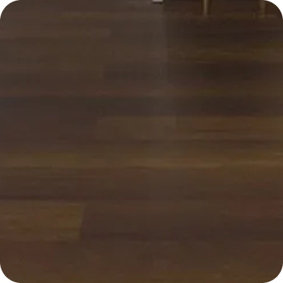 Smooth dark brown wooden floor with slight reflections and rounded corners.