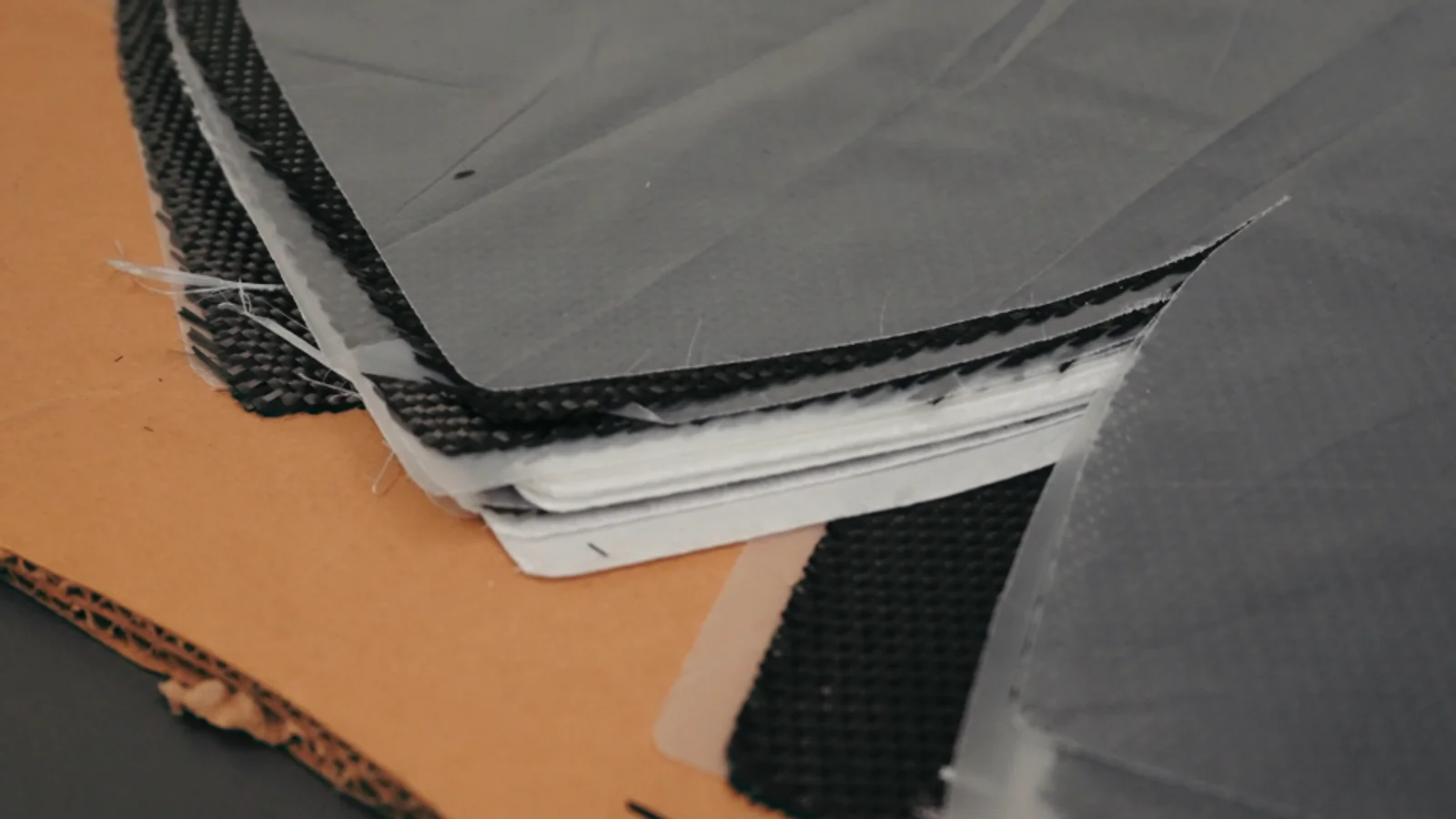 A worker handling a textile material