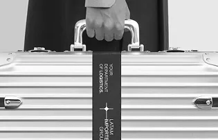 Hand holding a silver briefcase with a black strap labeled with placeholder text.