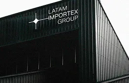 Dark building exterior with LATAM IMPORTEX GROUP logo near the roof peak.
