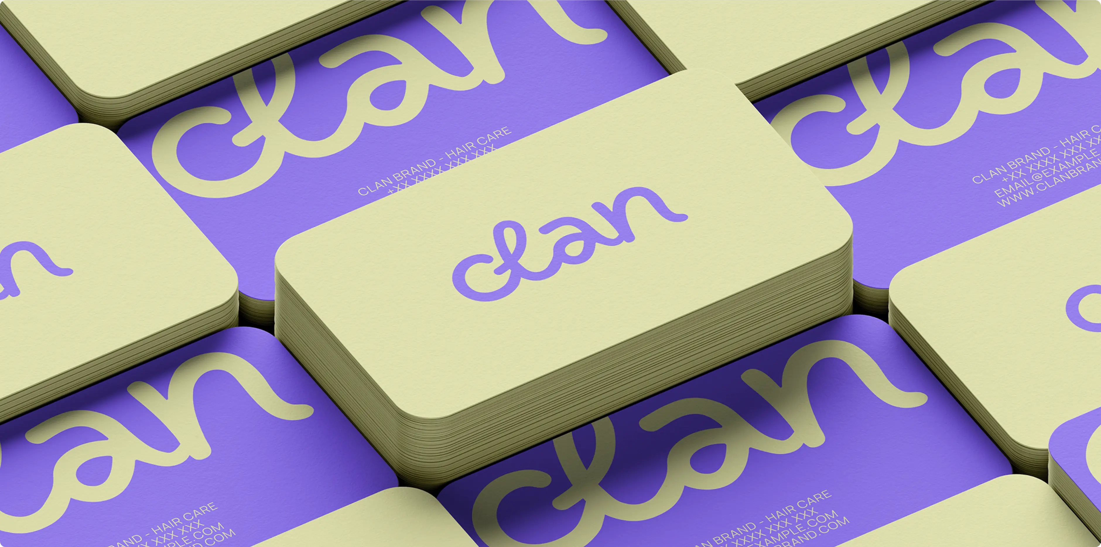 FANDS MARKETING AGENCY — Stacks of cream-colored and purple business cards with the word 'clan' in cursive and contact details for a hair care brand.