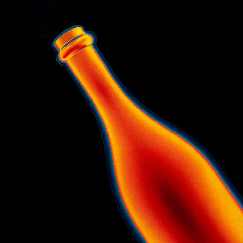 Thermal image of a bottle showing heat distribution with warm colors on a black background.
