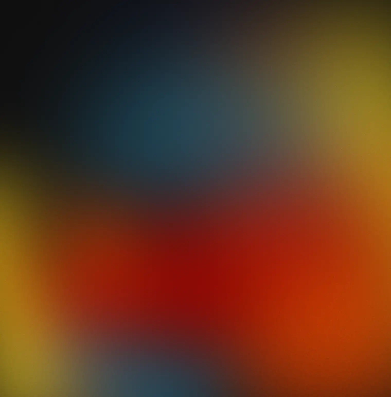 Abstract blurred colorful gradient background with blue, red, yellow, and black tones.