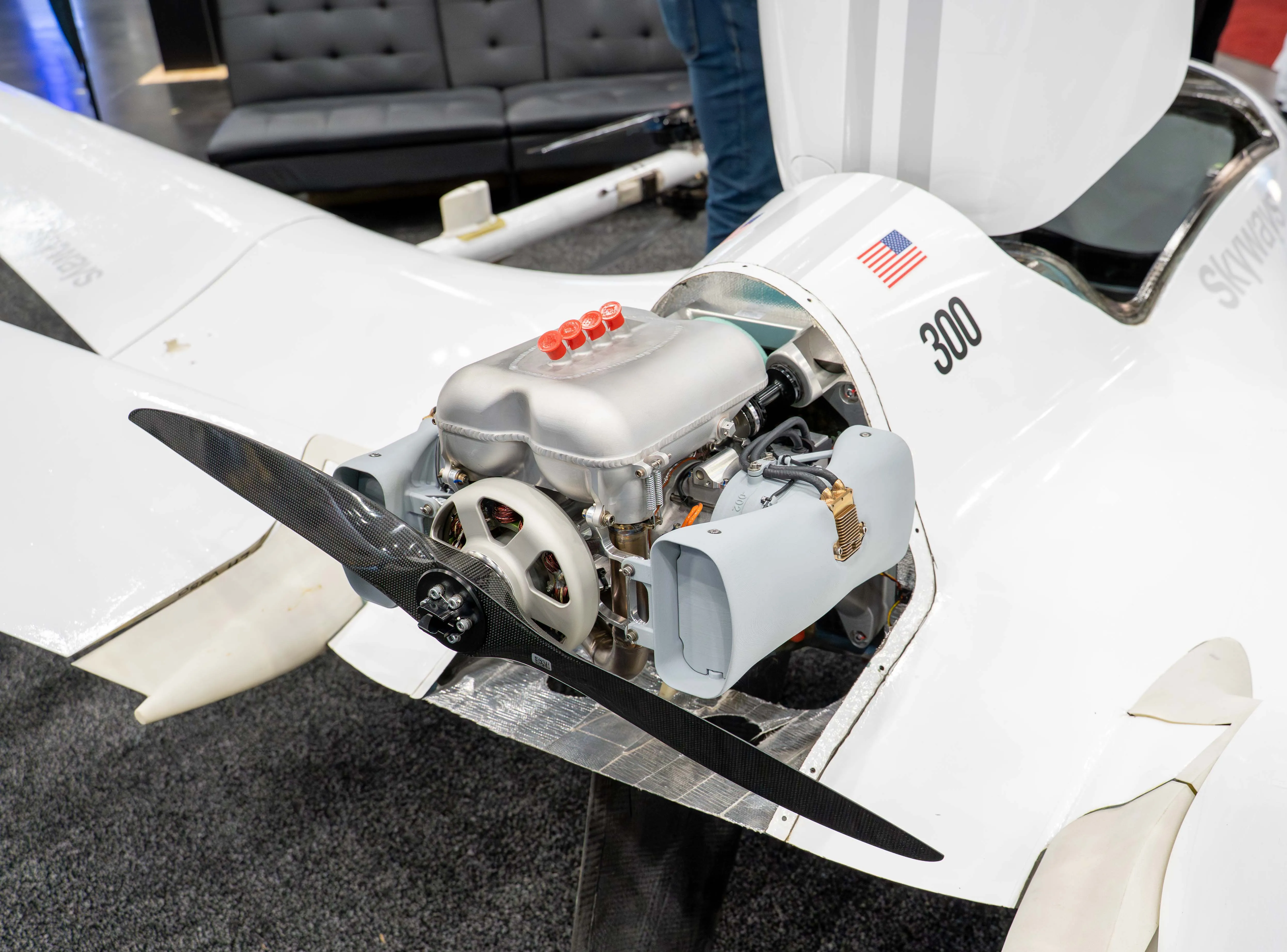 Alaris Pro | Blue and white helicopter with 'ROTOR.AI' on its side parked on a runway under a cloudy evening sky.