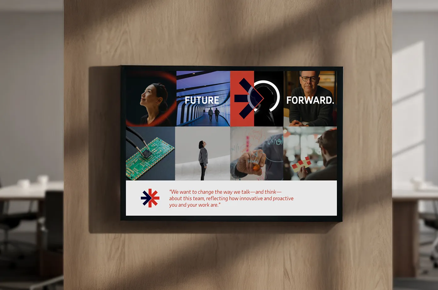 Wall-mounted screen displaying a collage with the words 'FUTURE FORWARD.', images of people, technology, and a quote about innovation and proactivity.