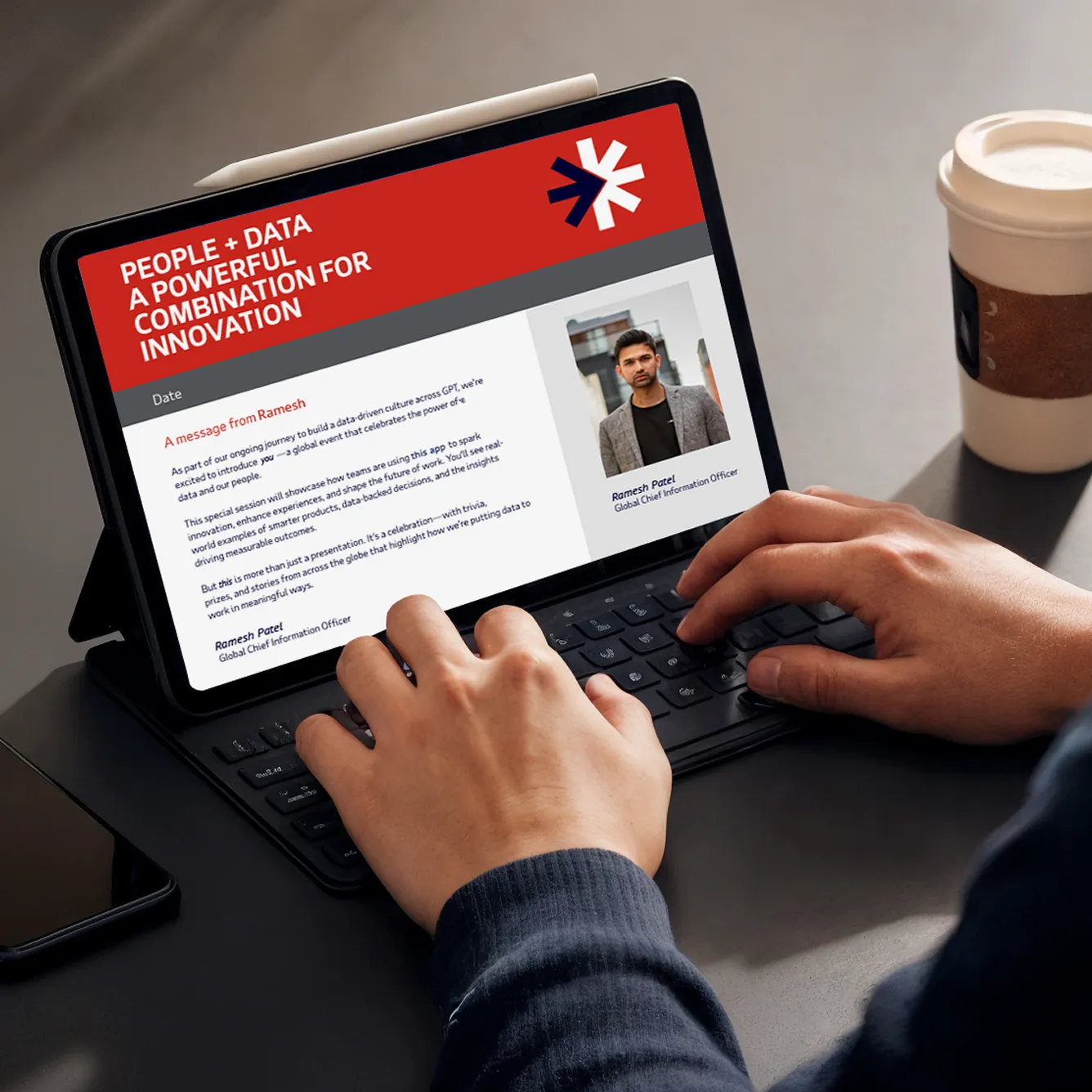 Person typing on a tablet with a keyboard showing a digital letter titled 'People + Data A Powerful Combination For Innovation' from Ramesh Patel, Global Chief Information Officer.