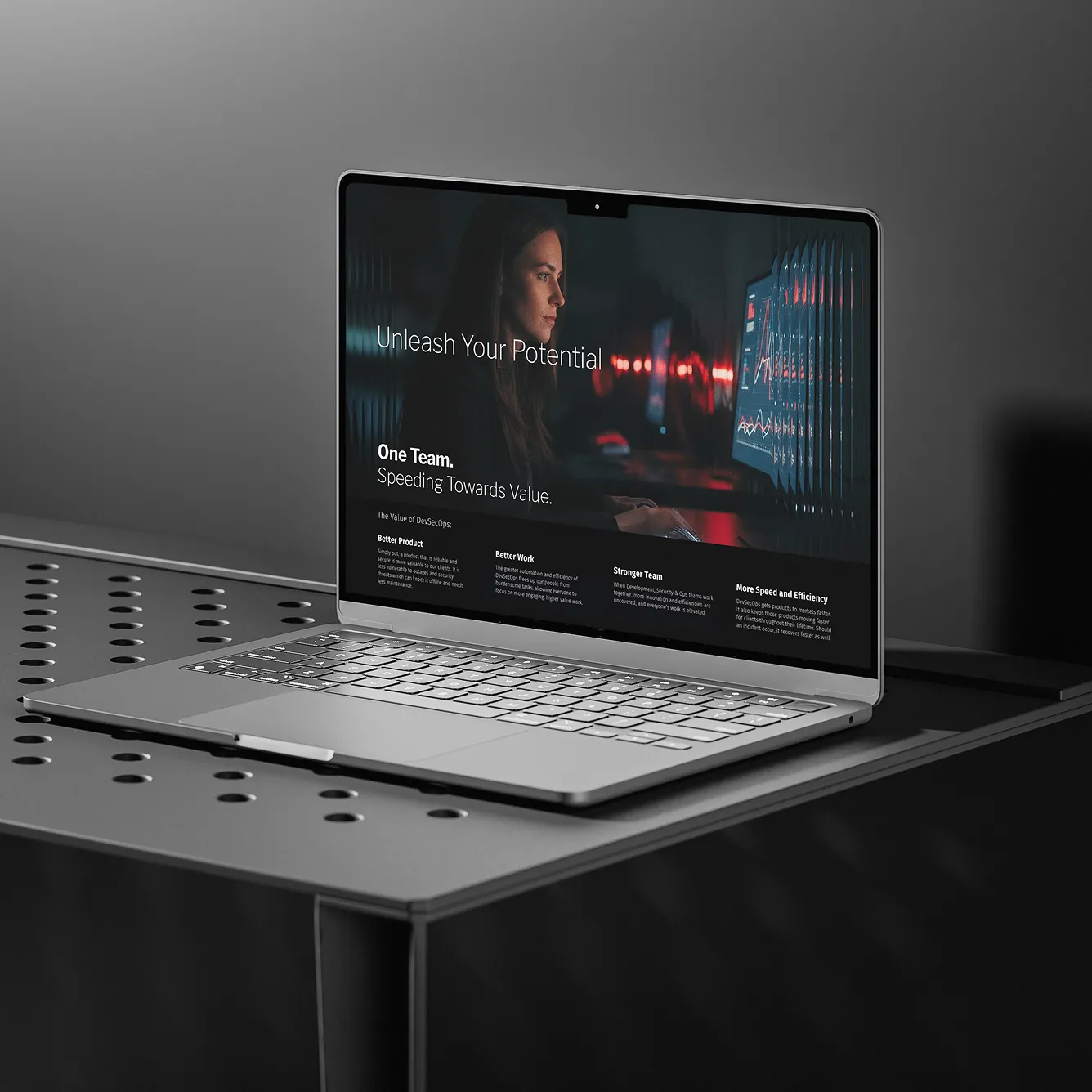 Modern laptop on a perforated metal table showing a screen with a woman and text about unleashing potential and DevSecOps benefits.