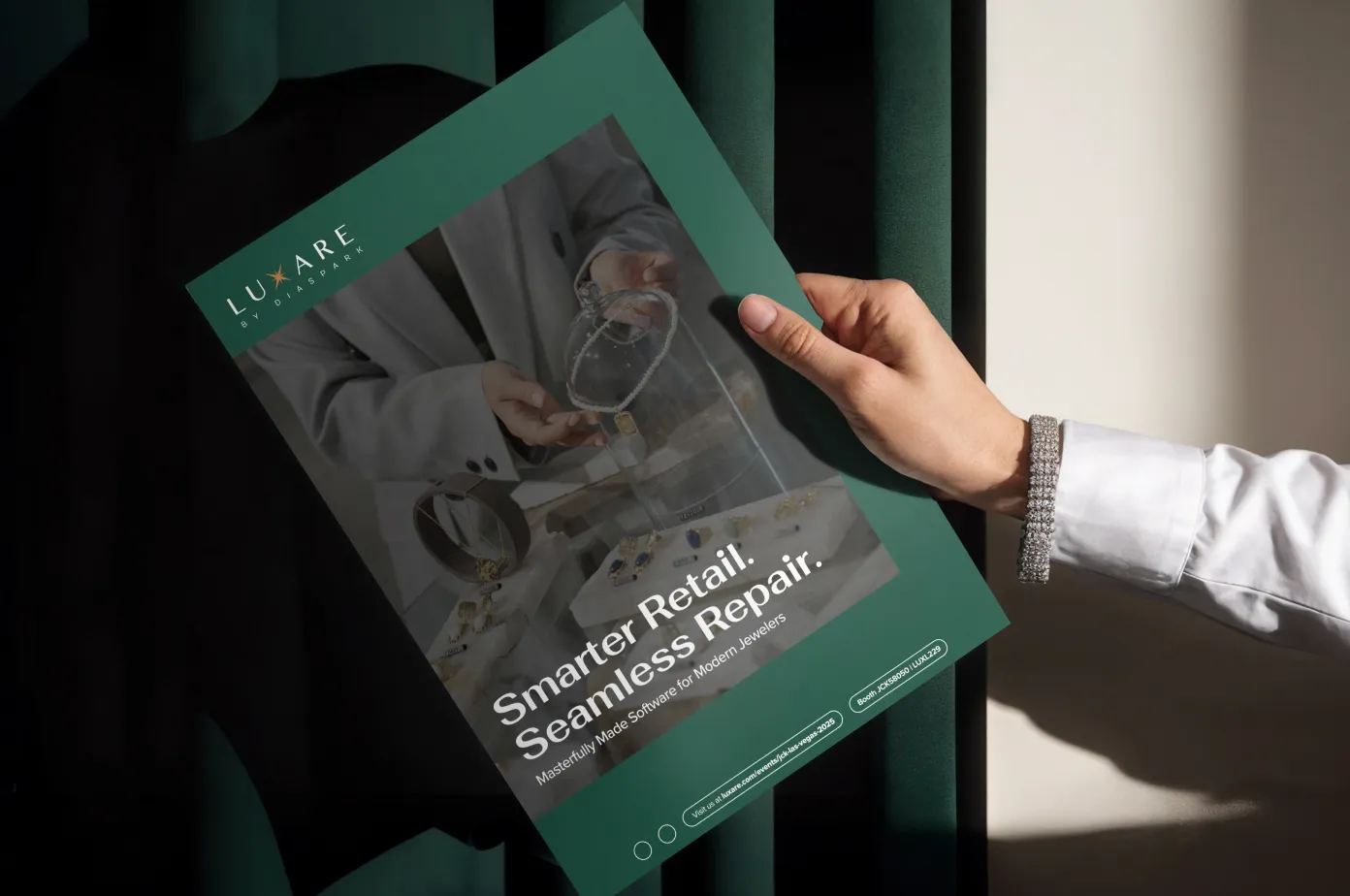 Hand holding a green promotional flyer for LUXARE jewelry retail software, featuring the text 'Smarter Retail. Seamless Repair.' and images of jewelry pieces.