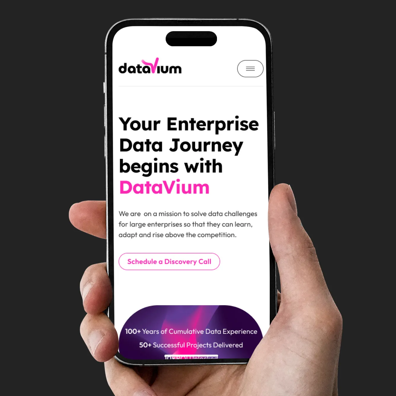 Hand holding a smartphone displaying a DataVium webpage with text about enterprise data journey and a button to schedule a discovery call.