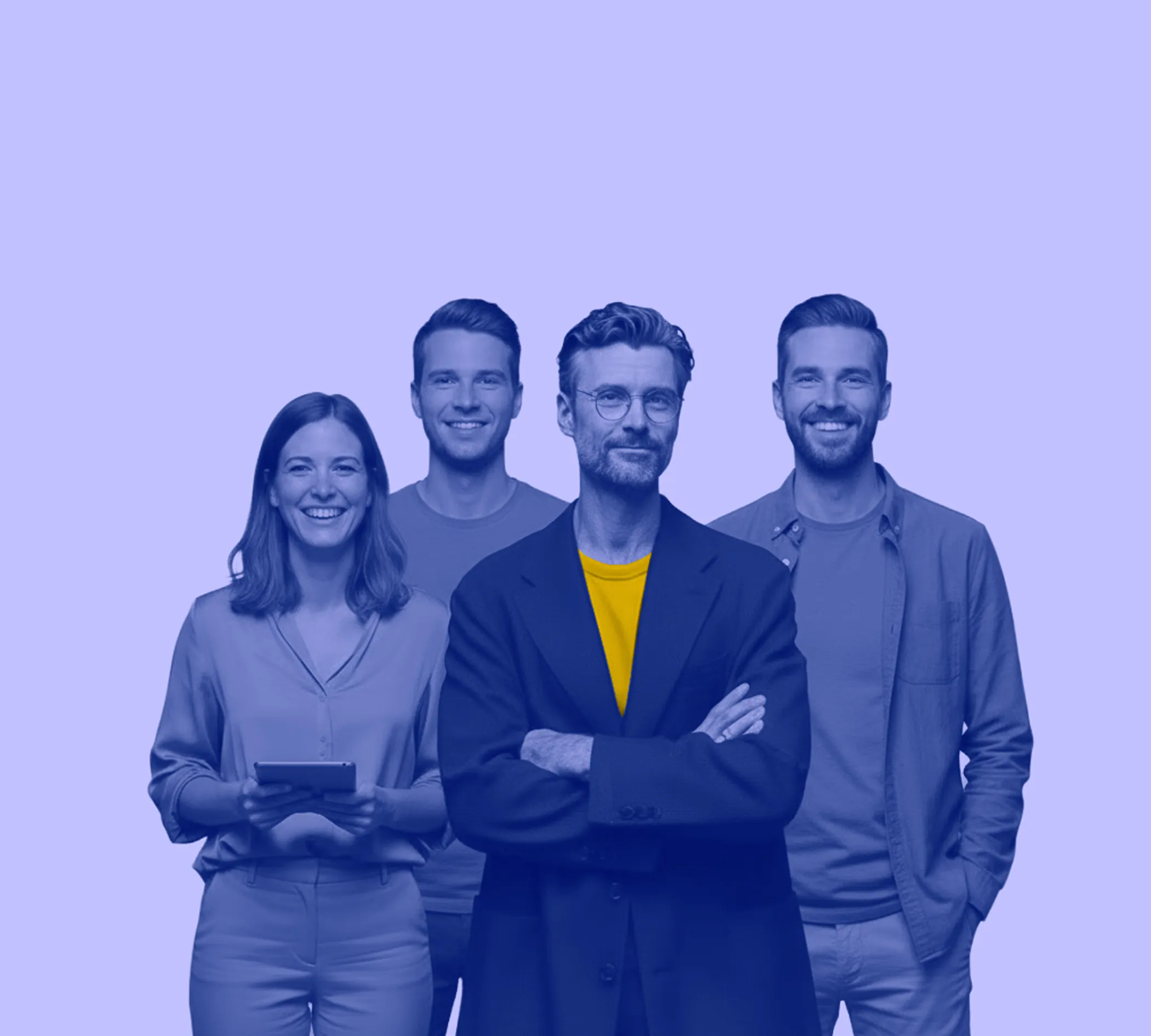 Group of four smiling professionals standing against a light background, with the man in front wearing a yellow shirt under a coat.