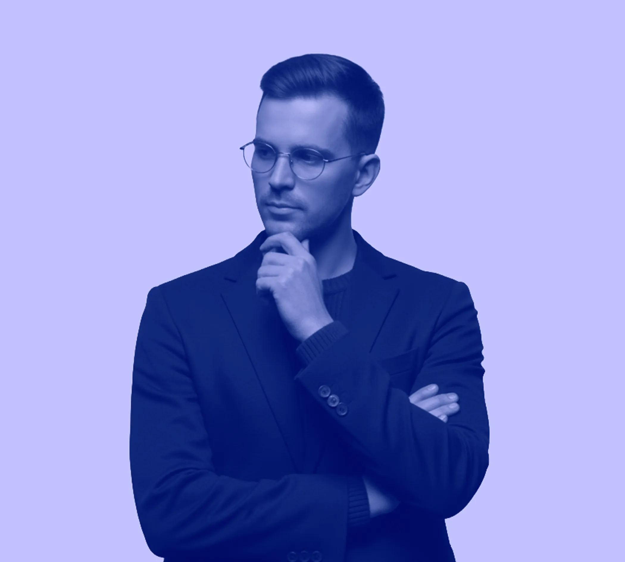 Man with glasses wearing a blazer, thoughtfully looking to the side with hand on chin against a plain background.