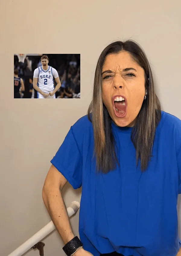 Katie Zarrilli in blue shirt with long hair yelling or expressing excitement, with an inset image of a basketball player in a Duke jersey celebrating.