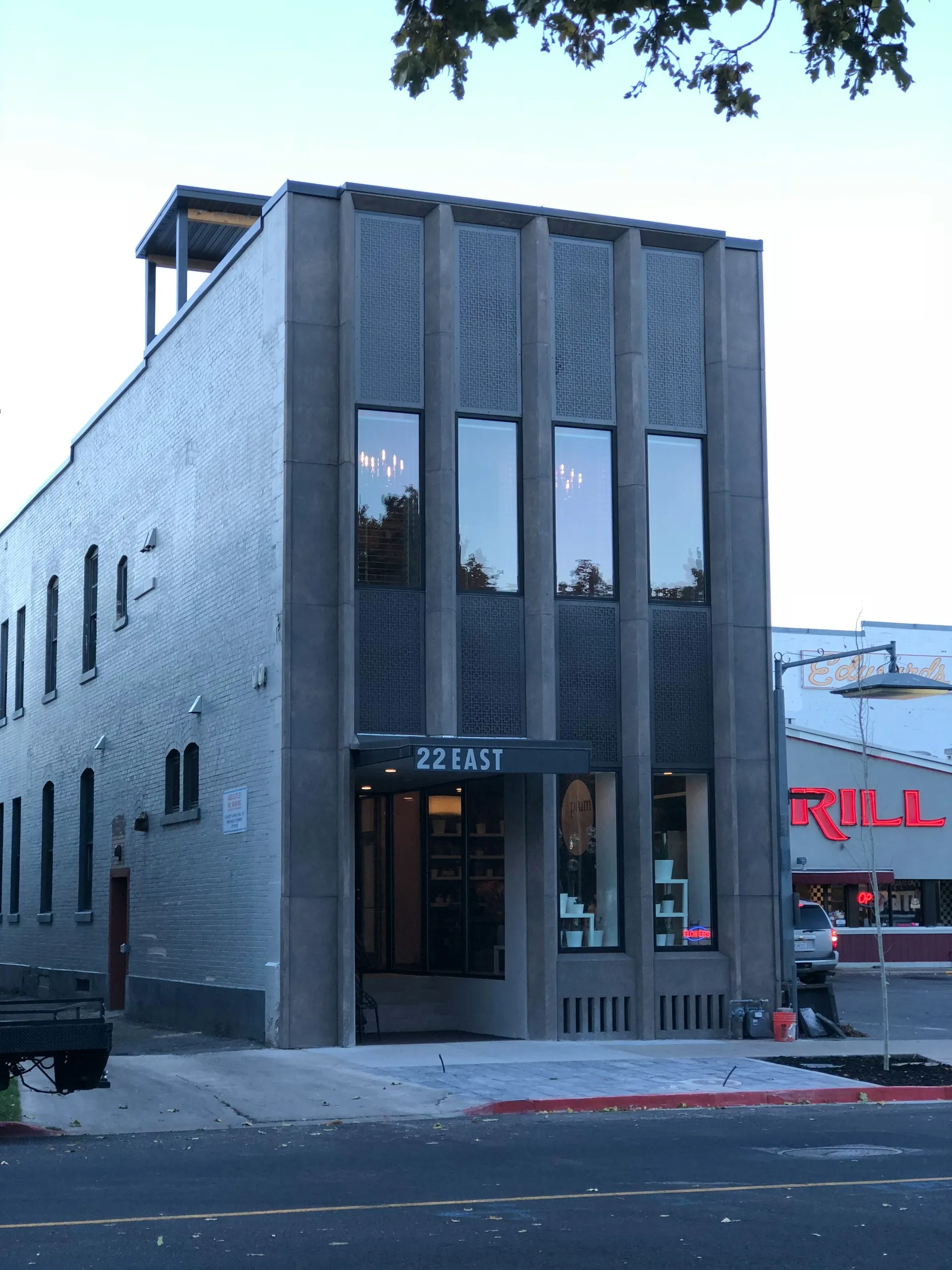 Two-story corner building with large vertical windows and a sign reading '22 EAST' above the entrance.