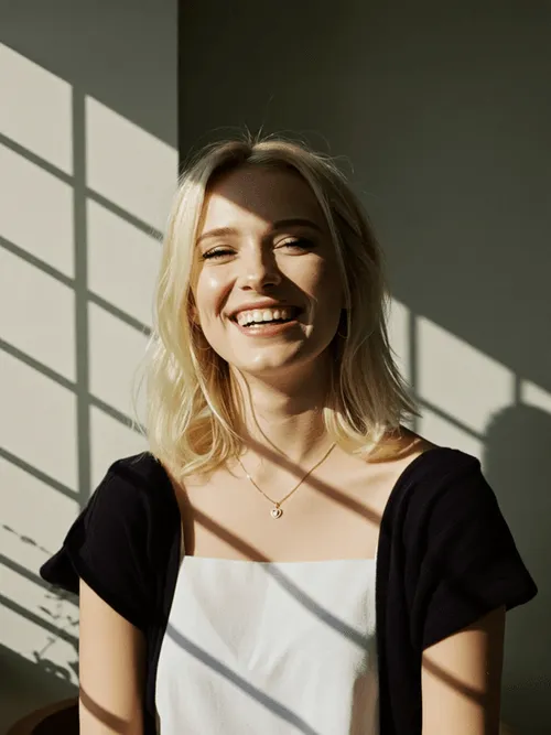 A woman is smiling and posing for a picture.