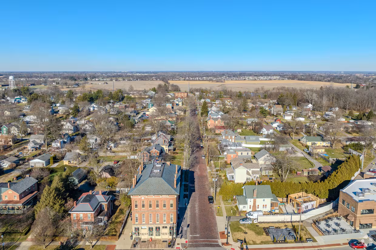 Aerial view of Groveport with brick buildings, residential houses, and a clear blue sky.