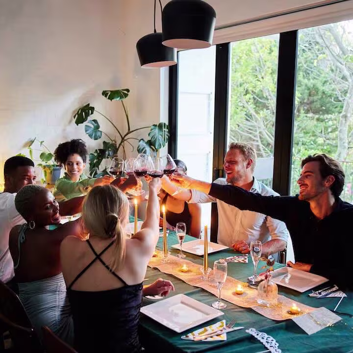 friends gathering for a dinner party at a swimply homes listing for rent by the hour