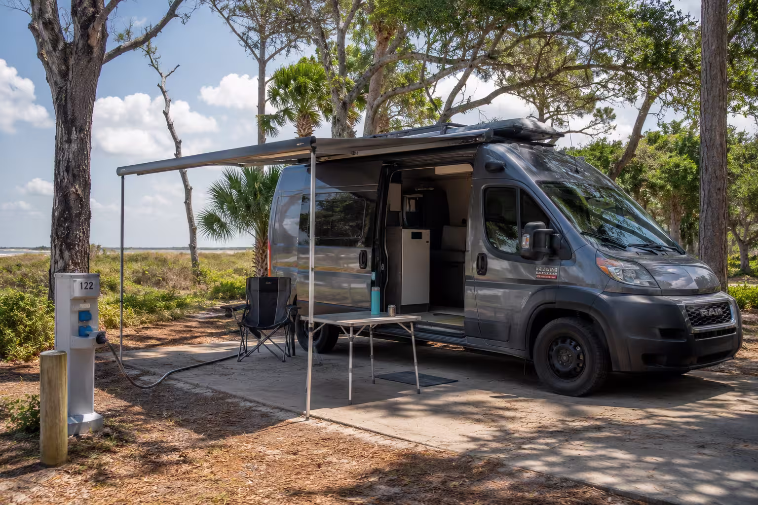 Camper van set up at a shaded campsite near Jacksonville