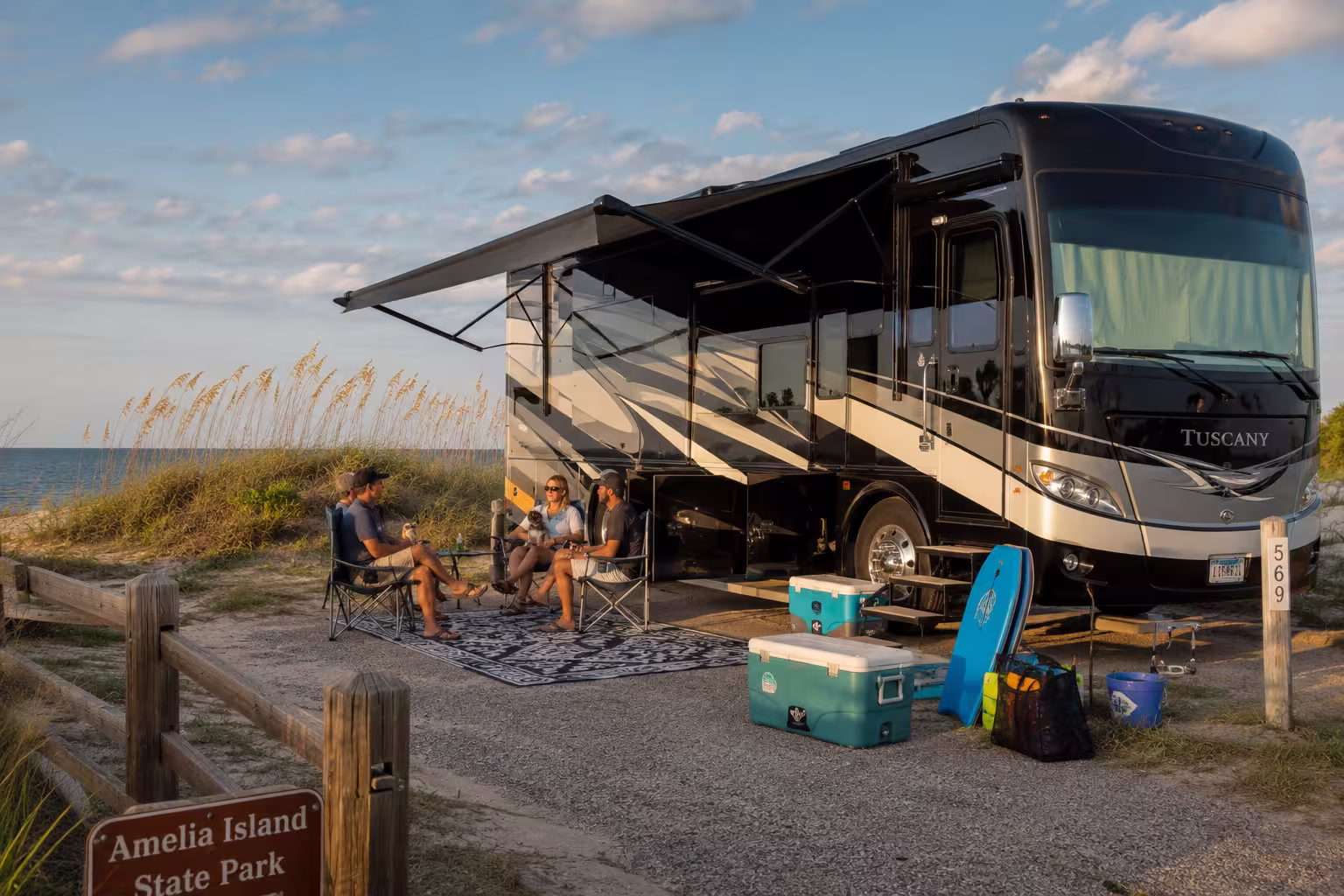 Class A motorhome at an Amelia Island RV site with a relaxing group