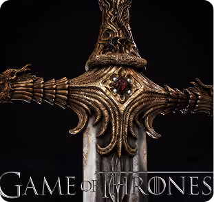 Close-up of ornate golden sword hilt with a red gem and Game of Thrones text below.