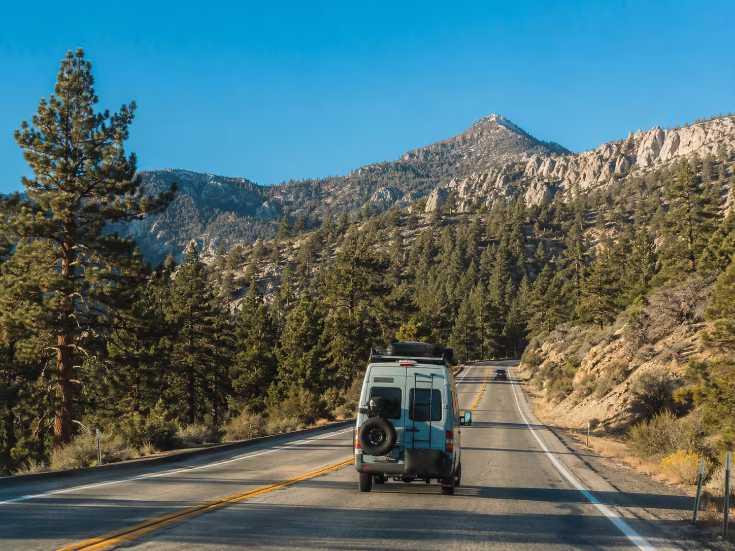 Small campervan on a mountain road toward Big Bear