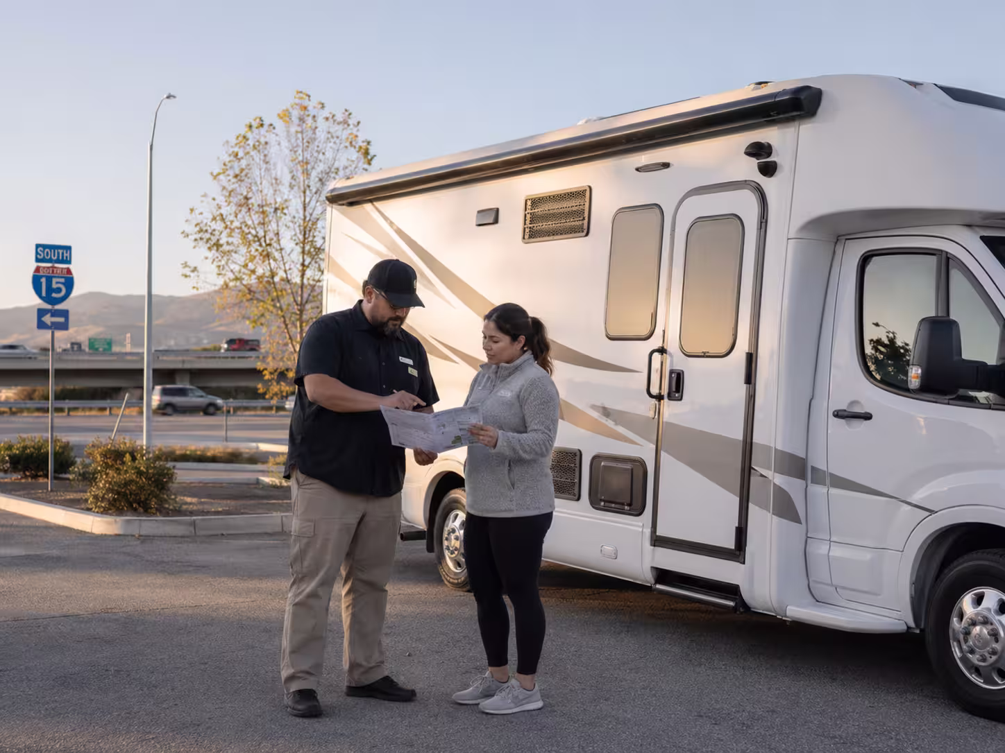 Manager helping a renter check a small RV in Murrieta