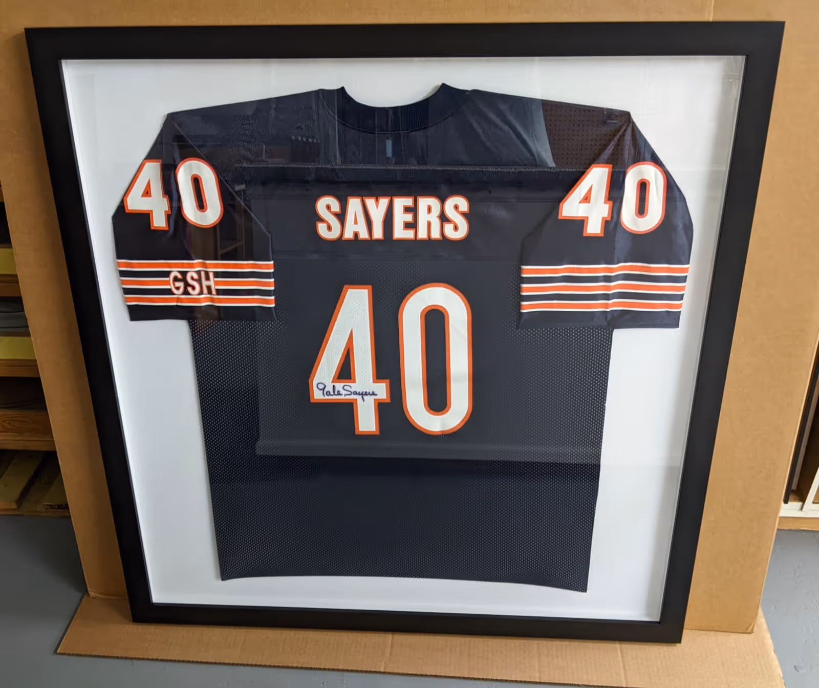 Framed black Chicago Bears football jersey with the number 40 and name Sayers, signed on the number 40.