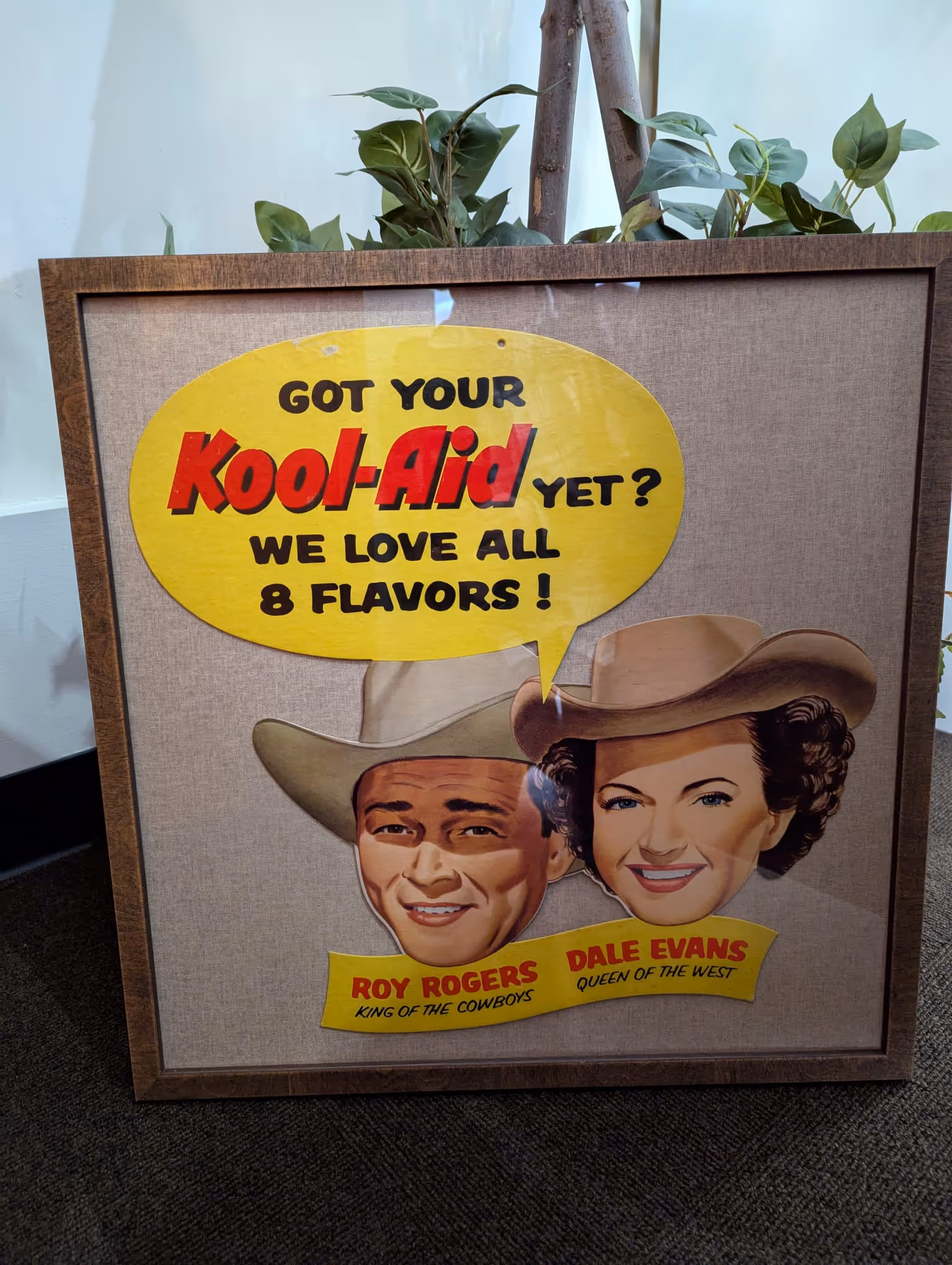 Framed vintage Kool-Aid advertisement featuring Roy Rogers and Dale Evans with a speech bubble saying, 'Got your Kool-Aid yet? We love all 8 flavors!'