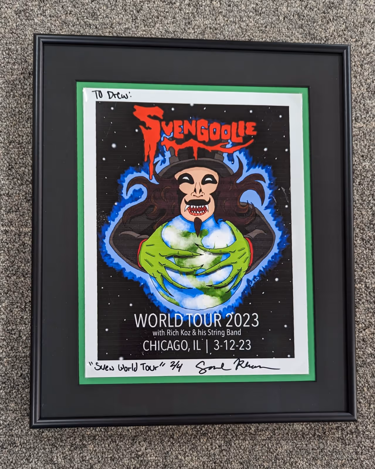 Framed poster for Svengoolie's World Tour 2023 in Chicago, featuring a cartoon figure with green hands holding Earth, and red dripping text.