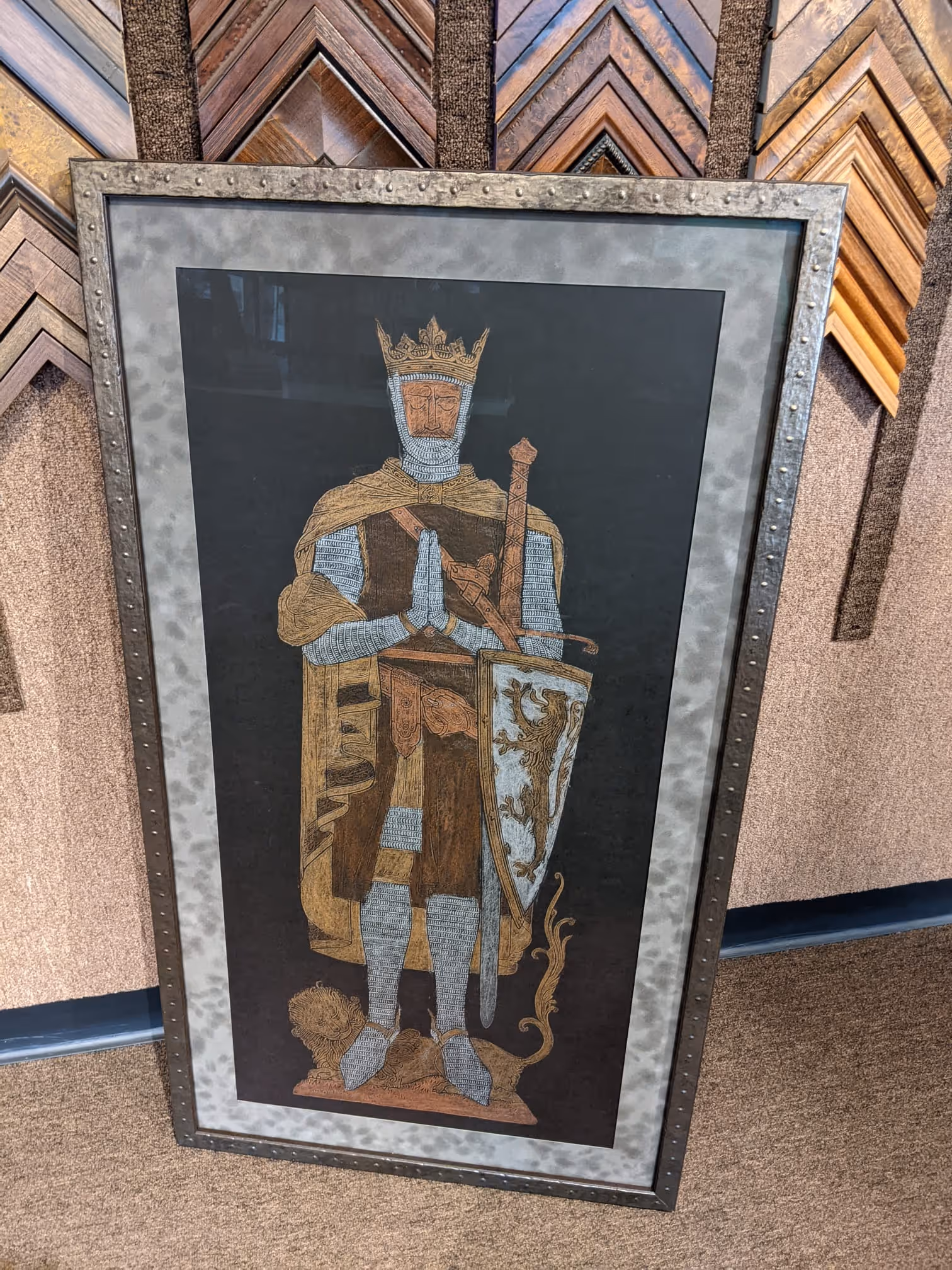 Framed medieval-style illustration of a crowned knight in chainmail armor with a shield featuring a lion emblem.