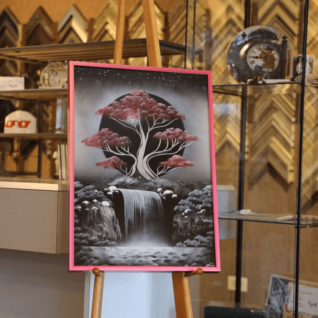 Painting of a tree with pink foliage above a waterfall, framed in pink, displayed on an easel in an art gallery.