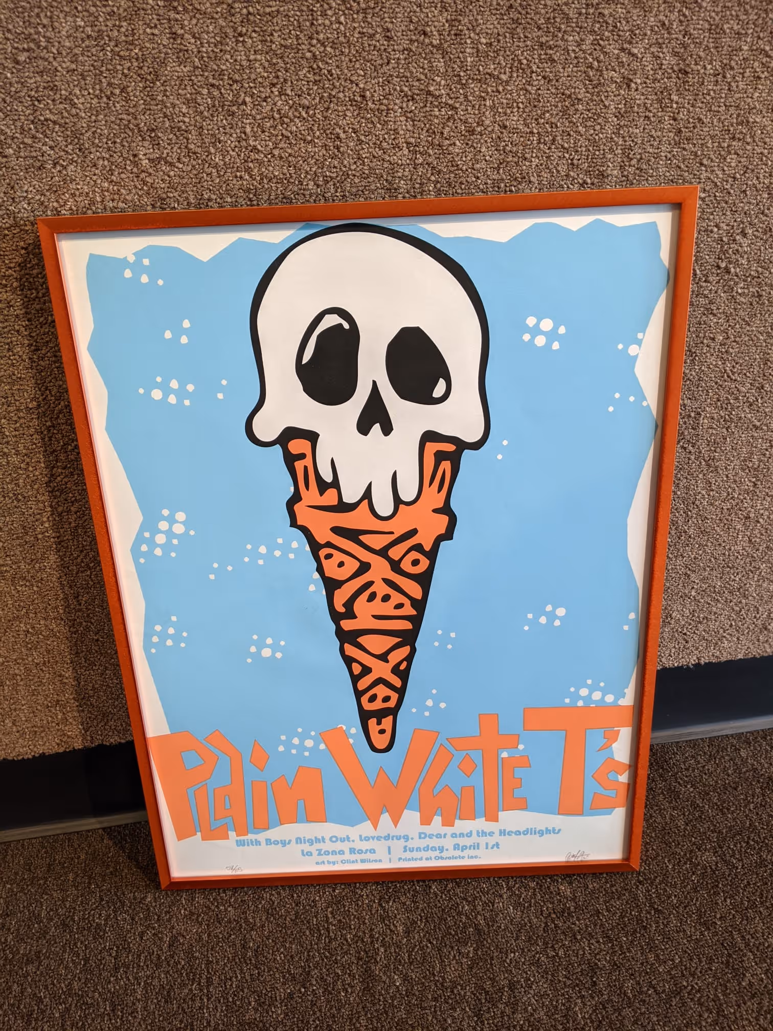 Framed poster of an ice cream cone with a skull-shaped scoop against a blue background with white dots, promoting a Plain White T's concert.