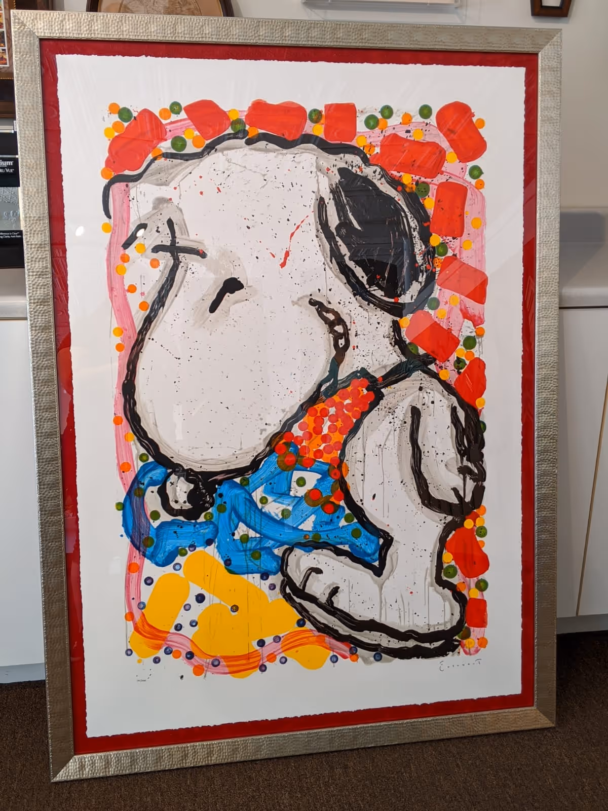 Framed abstract painting of Snoopy with bright multi-colored dots and shapes on a white background.