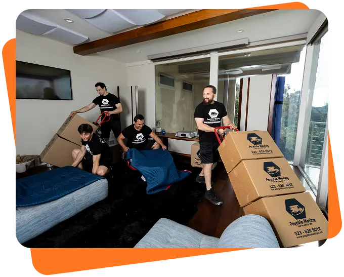 Payable Moving Company crew packing furniture and stacking branded moving boxes inside a modern Los Angeles home