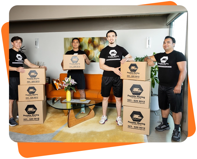 Payable Moving Company team standing in a living room with branded moving boxes during a residential move