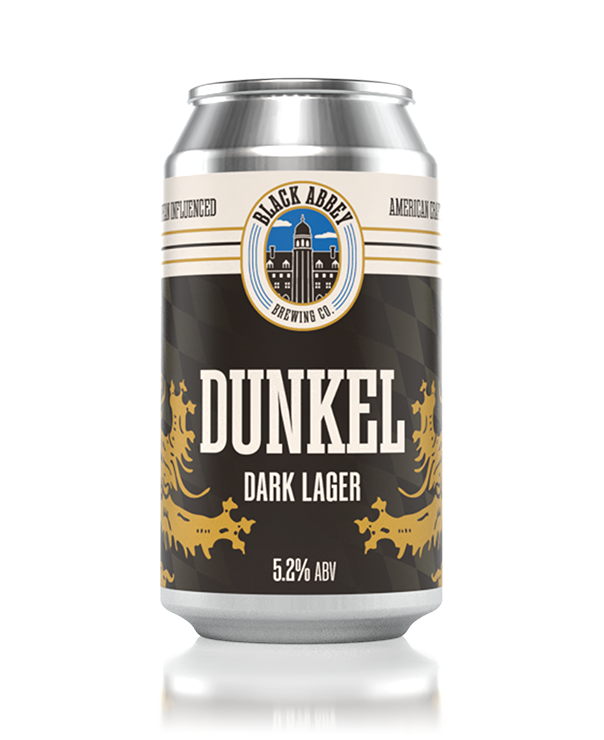 Can of Black Abbey Brewing Co. Dunkel dark lager beer with 5.2% ABV, featuring gold decorative lion designs.