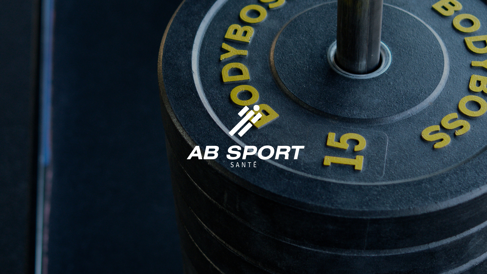 Poids de musculation noirs empilés avec l'inscription 'BODYBOSS 15' en jaune.