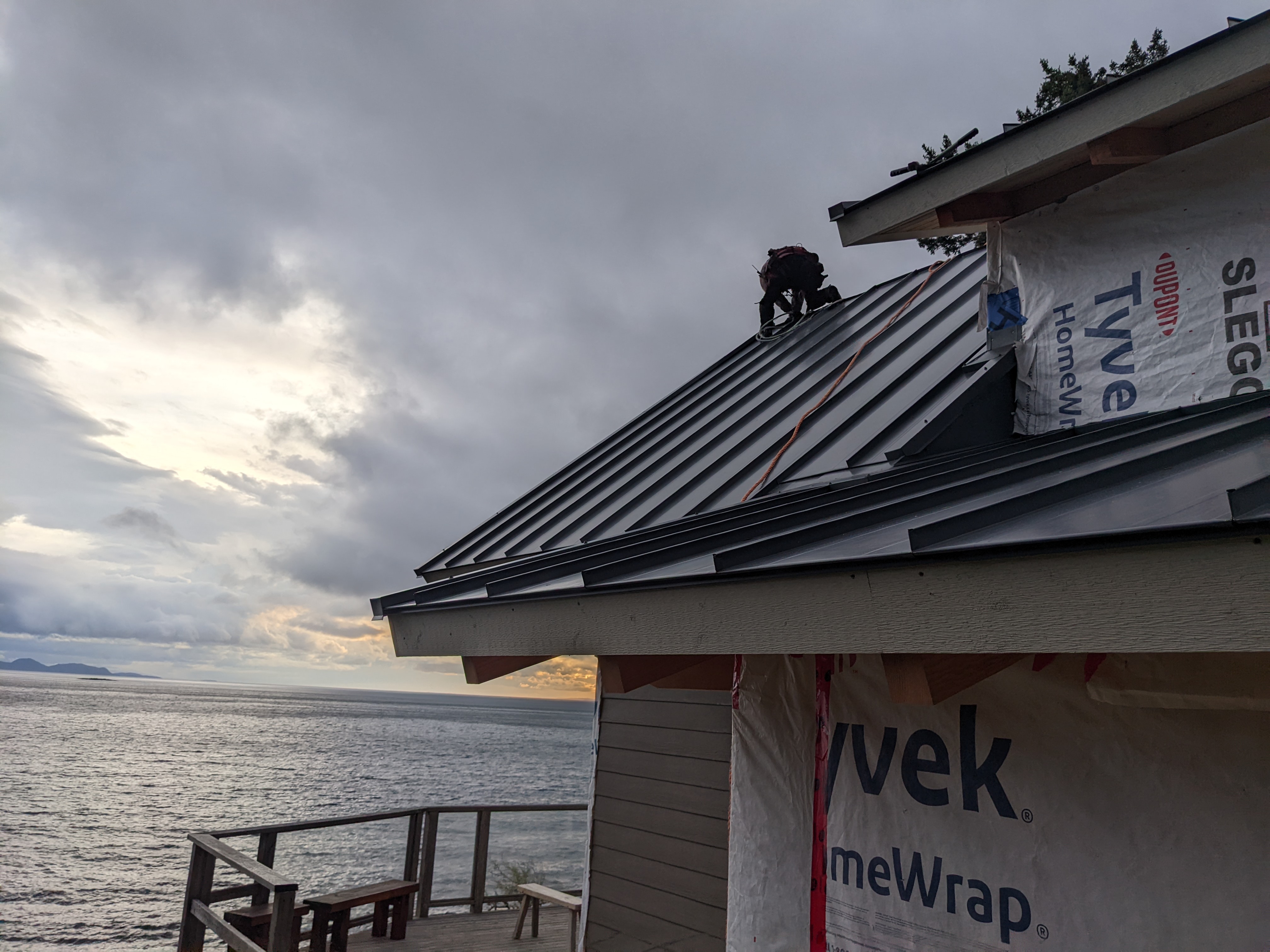 standing seam metal roof and house wrap on an oceanfront home under construction