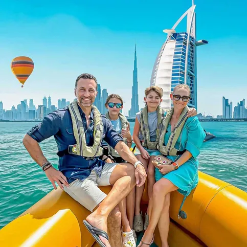 The Lockwood family sitting on an inflatable boat in front of the Dubai skyline