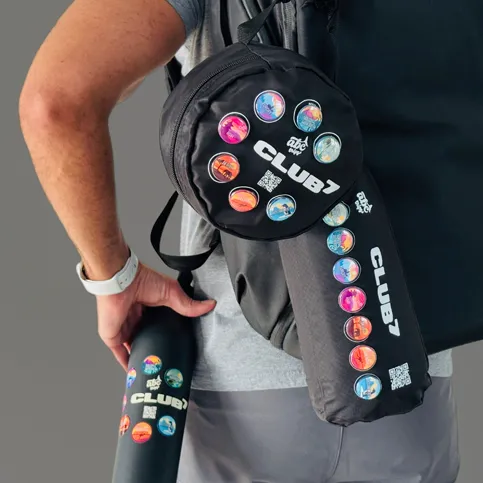 Club⁷ travel merch from ABC Trips, hanging on a backpack