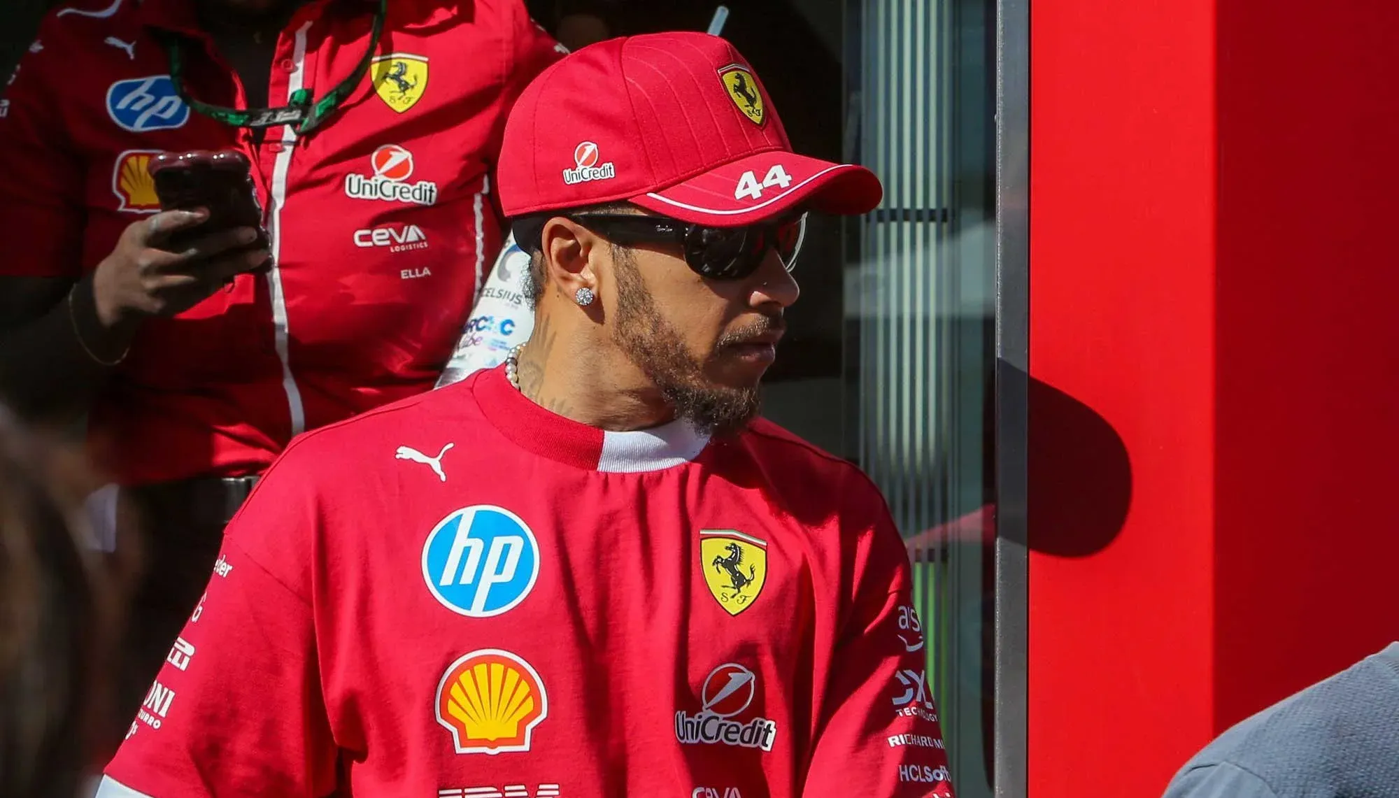 Lewis Hamilton emerges from a race trailer