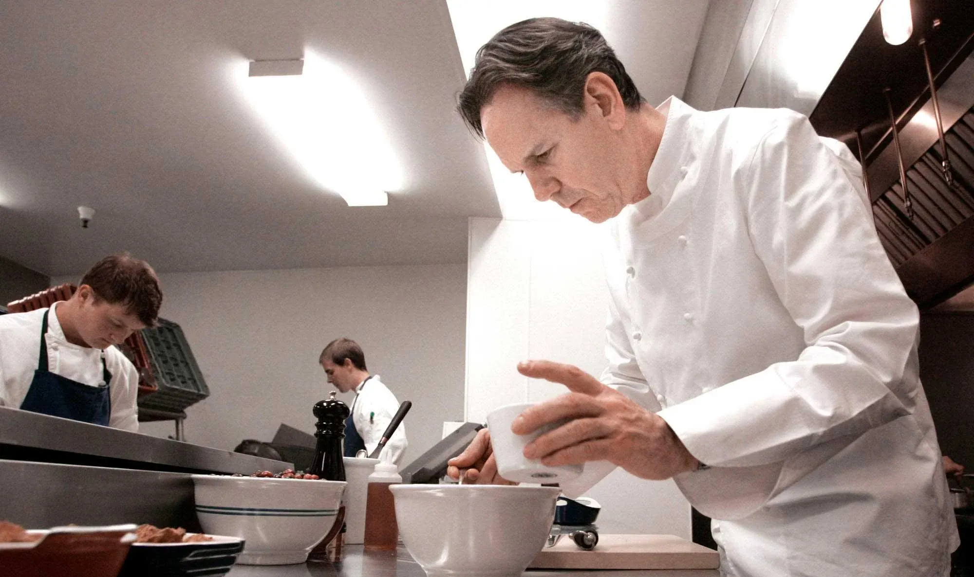 A chef prepares meals in a restaurant kitchen